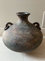 Front view of bulbous pottery vase with two loop handles