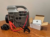 Full view of power station with cables, AC adapter and boxed solar charger