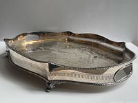 Angled view showing pierced gallery, footed base and tarnish