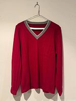 Full front view of red V-neck sweater on hanger
