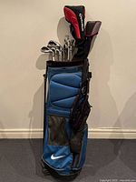 Full view of blue Nike stand bag with clubs