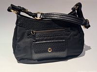 Front view of Prada black nylon bag with leather flap pocket and zip pocket