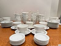 Stacked saucers and cups with metal rack visible