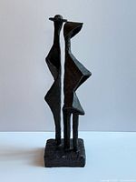 Full view of bronze abstract sculpture on white background