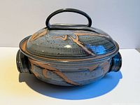 Full view of covered dish showing glaze, handles and lid