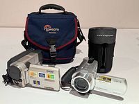 Overall lot showing two camcorders, Lowepro bag and Handycam case