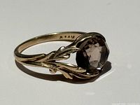 Side view showing smoky quartz and leaf motif setting, 14K hallmark visible