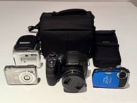 Group shot of four cameras with bag and pouches