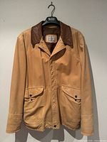 Front view of tan leather field jacket showing pockets and collar