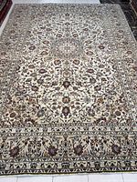 Full view of entire rug showing field, borders and overall coloration