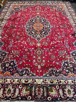 Full view of the Mashhad rug showing overall pattern and borders