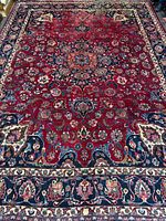 Full view of the Mashhad rug showing overall pattern and colors