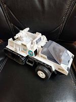 Left front view of Snow Cat showing decals, wheels, treads and missile launcher