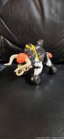 Right-side view of Fisher-Price Buckaroo Bull showing horns, saddle, and lariat