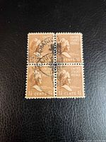 Front view of four-stamp block displaying design, denomination and cancellation marks