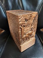 Front view showing wildlife relief panel on urn