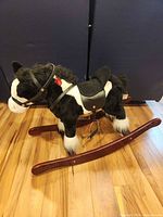 Full side view of plush rocking horse on wooden rockers