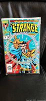 Front view of bagged Doctor Strange #50 comic showing full foil cover artwork