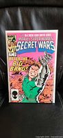 Front cover of Secret Wars #12 comic in protective bag and board