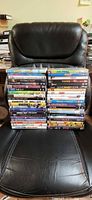 42 DVDs stacked on chair