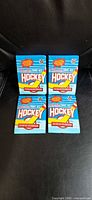 Front view of four sealed 1991-92 O-Pee-Chee hockey card packs