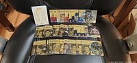 Overall lot of 50 Upper Deck Ice acetate cards spread out on chair with checklist visible
