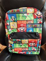 Front view of backpack showing Super Mario print and front pocket