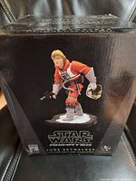 Front of box showing maquette image and branding