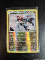 Front of sleeved Druddigon reverse holo rare card showing artwork, attacks, set number 83/114