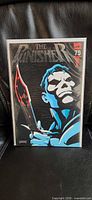 Front view of The Punisher #75 comic in bag with embossed foil cover visible