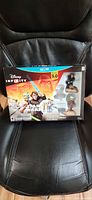 Front of sealed Disney Infinity 3.0 Star Wars Starter Pack box on chair