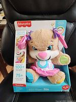 Front view of sealed Fisher-Price Laugh & Learn Smart Stages Sis doll in box