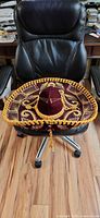 Full view of sombrero on chair showing shape, brim, embroidery, trim