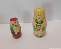 Largest Santa and blonde girl dolls standing