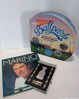 Front view of three sports books: baseball parks, Dan Marino, hockey
