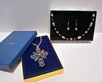 Two boxed jewelry sets: cross pendant necklace and beaded necklace-earrings