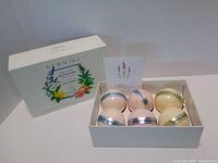 Newmiuz bath bomb gift set showing six bath bombs in open box alongside outer sleeve