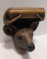 Front view of deer head wall shelf showing antler-supported ledge