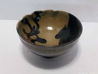 Interior view showing scalloped rim and brushstroke decoration