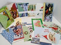All greeting cards and envelopes spread out to display designs