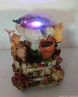 Front view of fountain illuminated showing animals and LED light