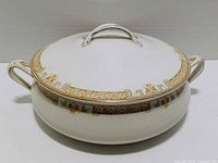 Lidded porcelain dish front view showing pattern and handles