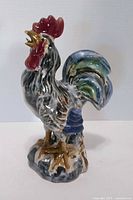 Front view of multicolor porcelain rooster figurine