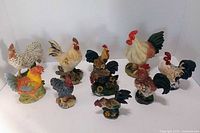 Front view of ten rooster figurines standing upright.
