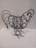 Front view of black metal rooster K-Cup holder