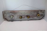 Front view showing distressed finish and four assorted knob hooks