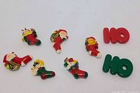 Front view of eight Christmas button covers