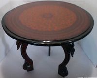 Round lacquered tabletop with red pattern