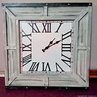 Front view showing whitewashed wood frame, Roman numeral face and hands