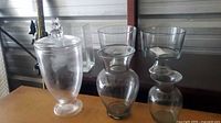 Group of clear glass vessels on table